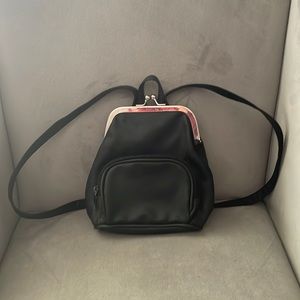 Purse backpack with vintage clip closure